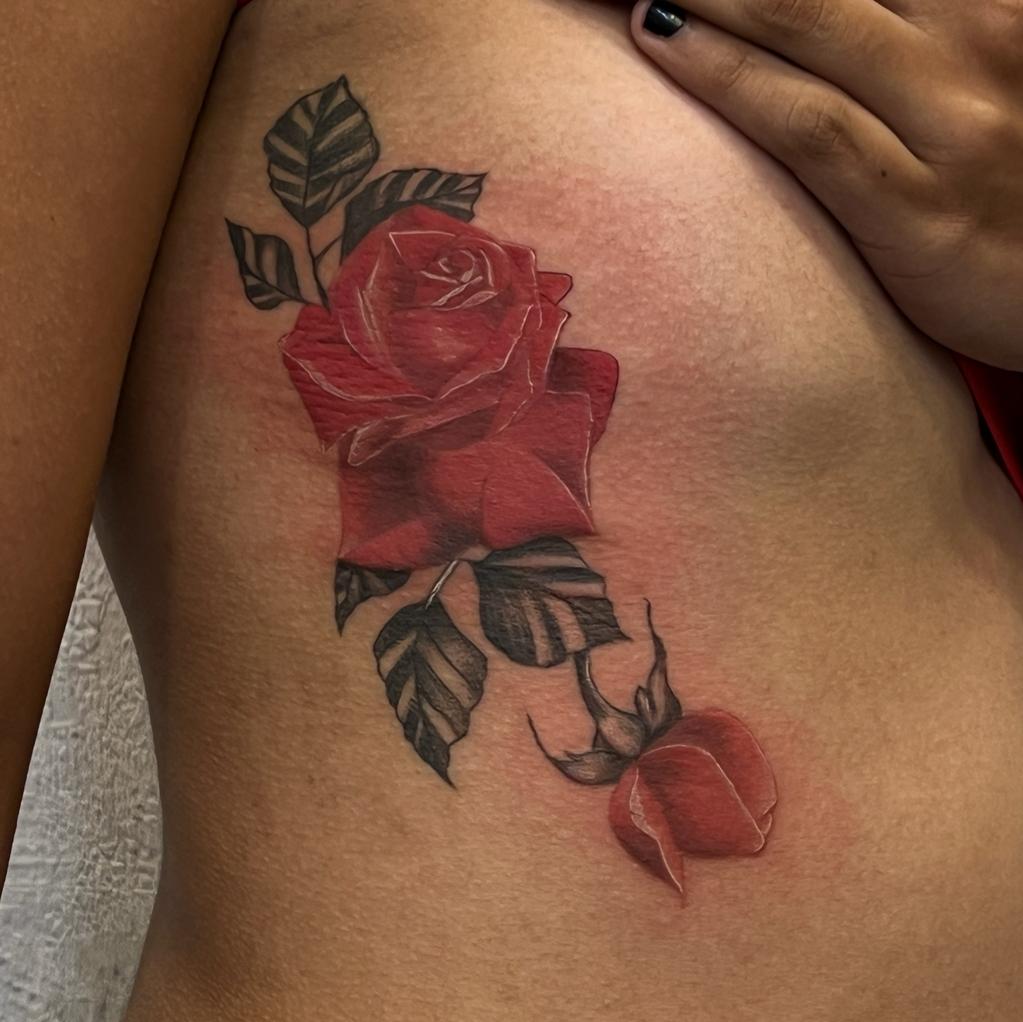 Naksh Tattoos - The traditional red rose tattoo symbolizes love and  passion. A pink rose represents grace, gratitude, and affection while  purple roses have been used to symbolize royalty and enchantment. The